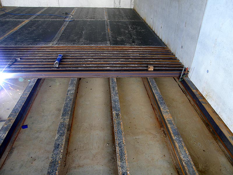 Stahlschienen und Lüftungsbleche bei der Montage des Trocknungsbodens
